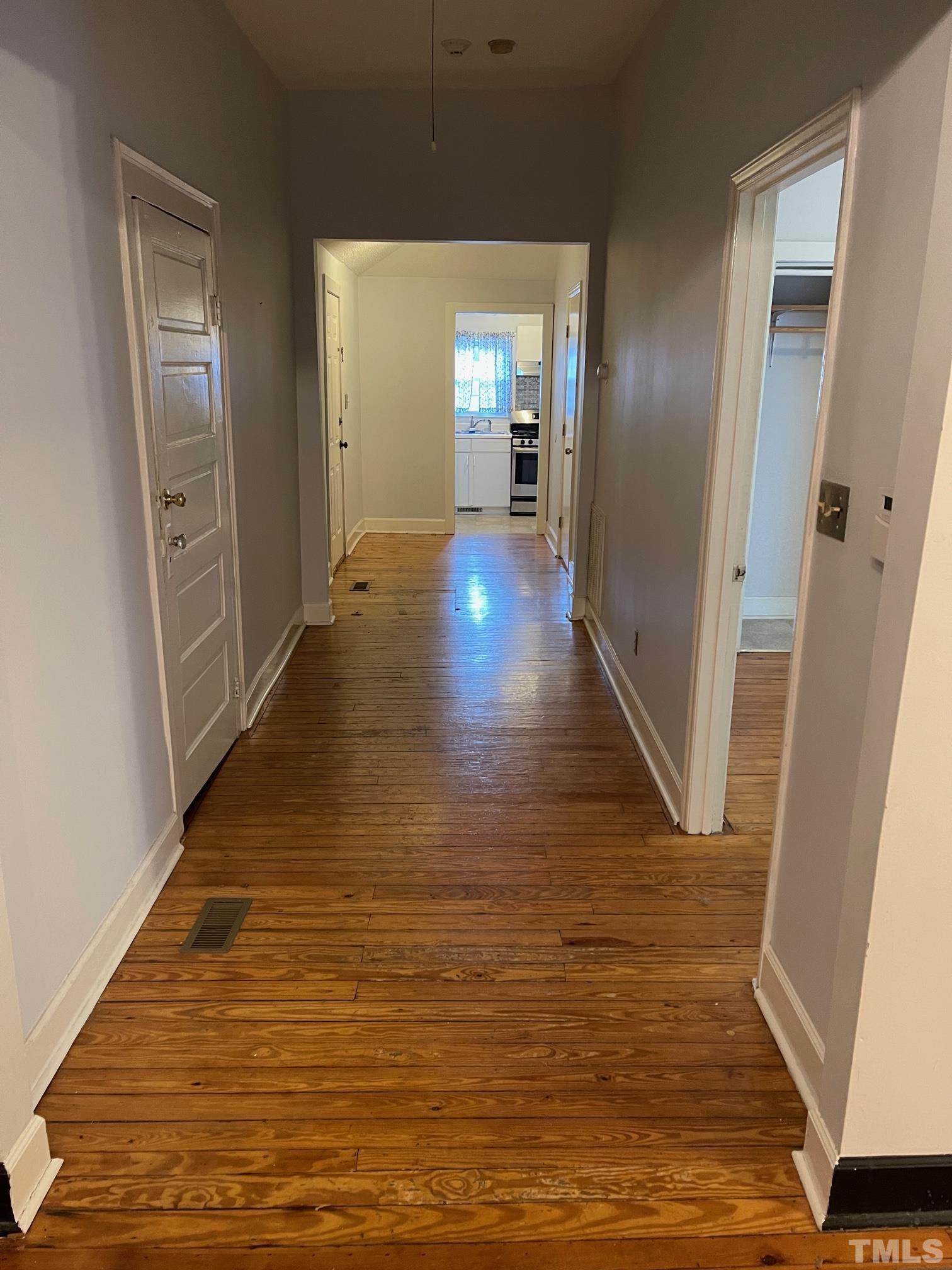 561 New Bern Avenue Raleigh, NC 27601 - Photo 6 of 15 a view of a hallway with wooden floor