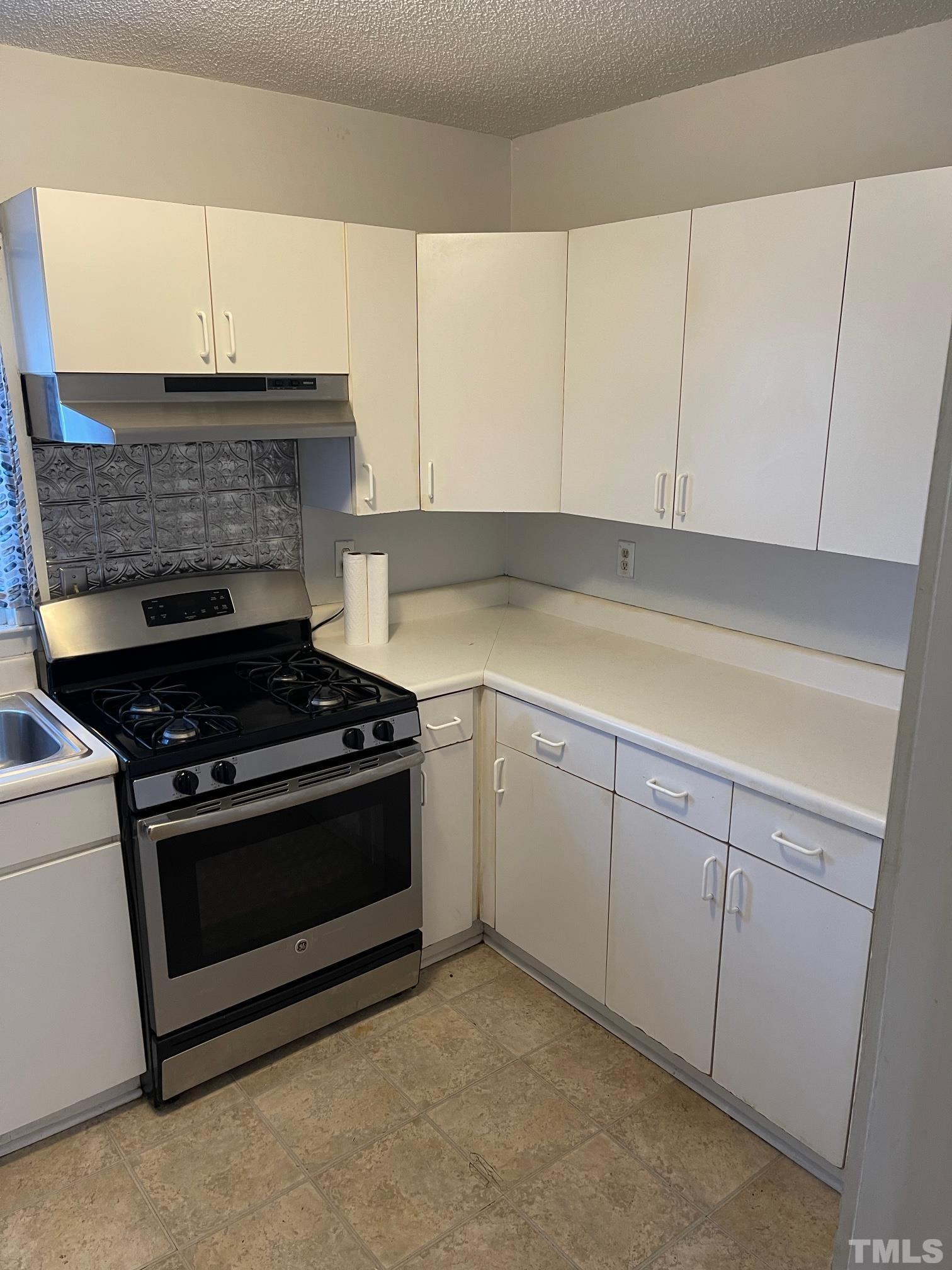 561 New Bern Avenue Raleigh, NC 27601 - Photo 8 of 15 a kitchen with cabinets and appliances