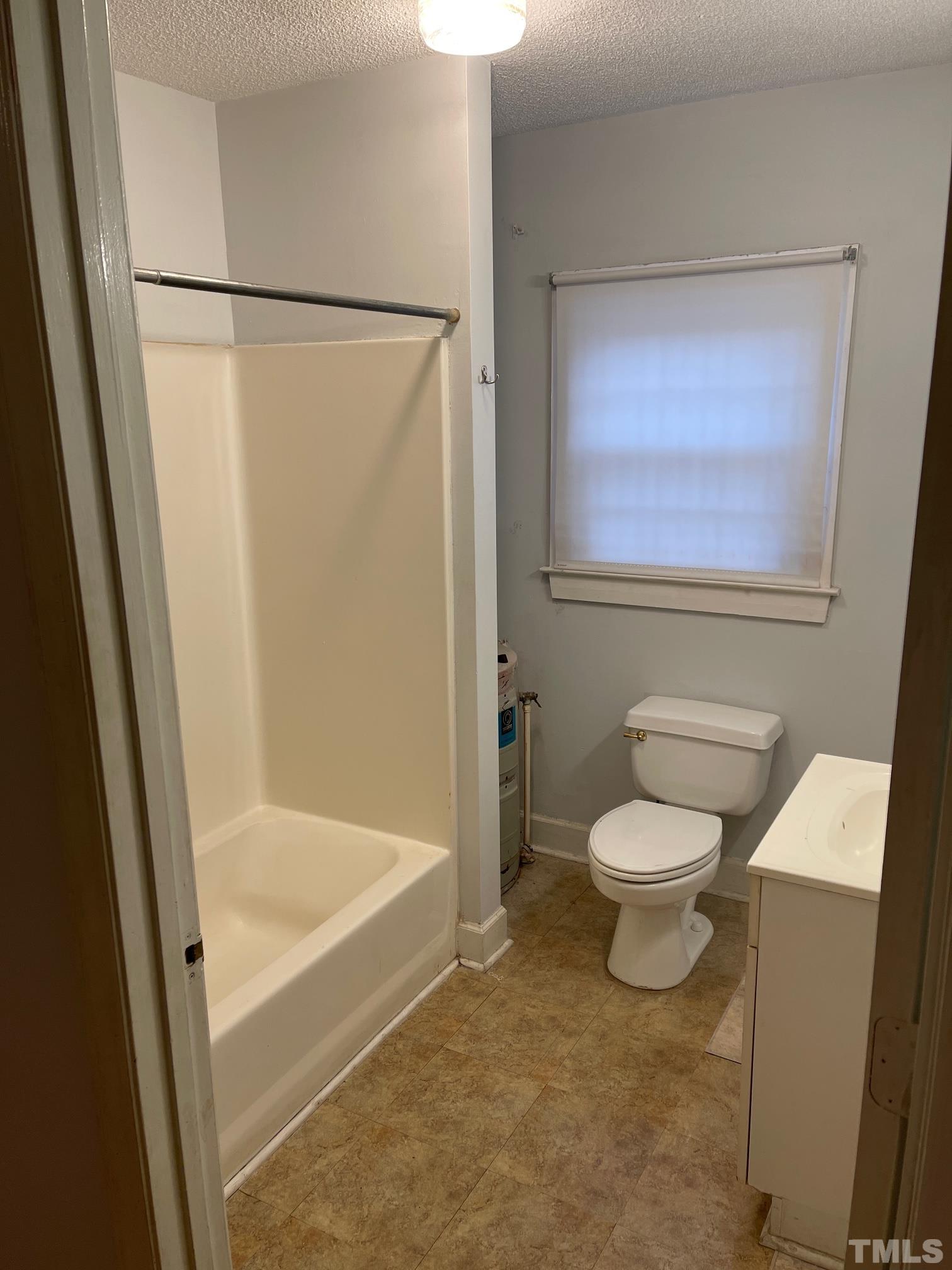 561 New Bern Avenue Raleigh, NC 27601 - Photo 10 of 15 a bathroom with a toilet and a shower