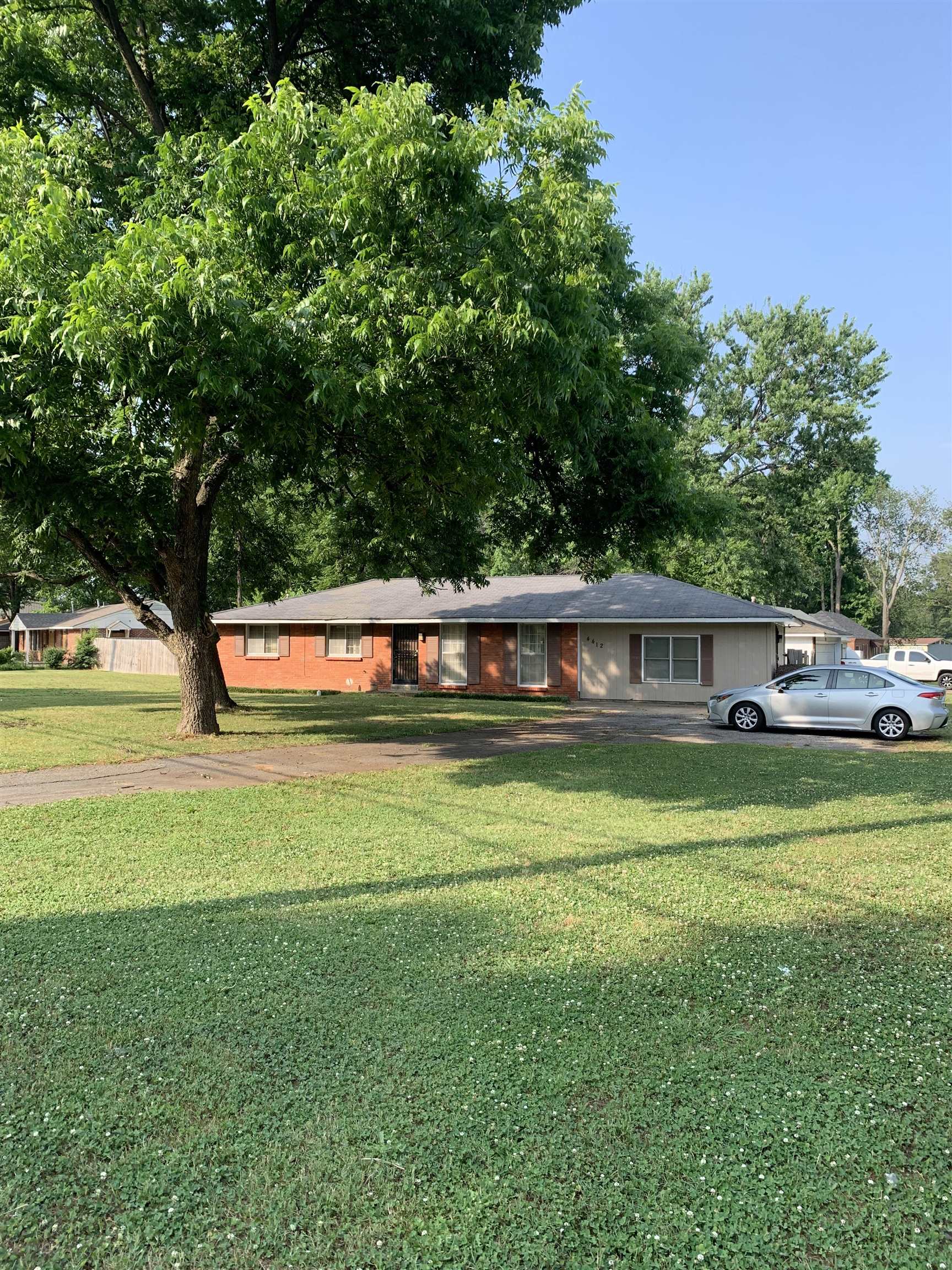 4412 Millbranch Road Memphis, TN 38116 - Photo 1 of 15 a front view of a house with a garden and swimming pool