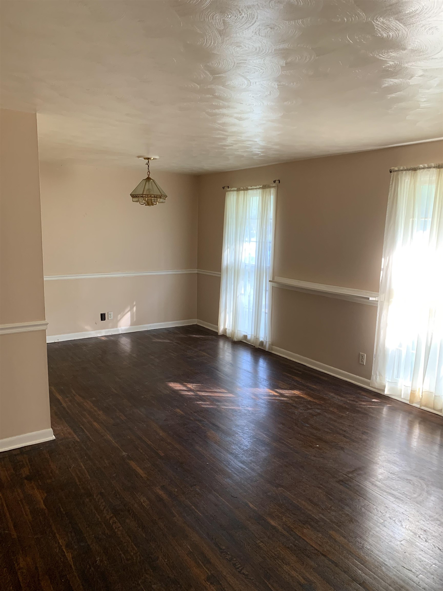 4412 Millbranch Road Memphis, TN 38116 - Photo 12 of 15 an empty room with wooden floor and windows