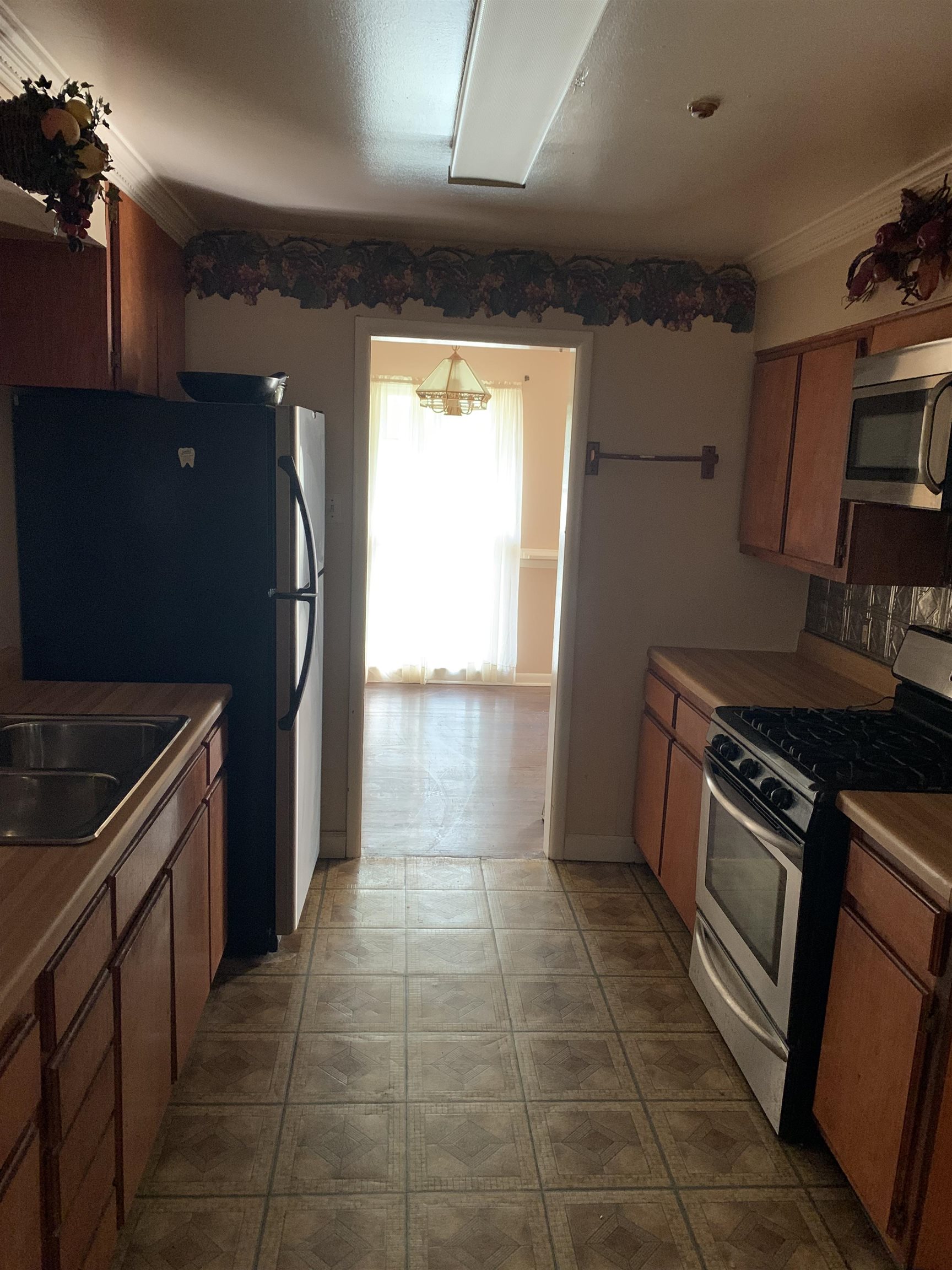 4412 Millbranch Road Memphis, TN 38116 - Photo 15 of 15 a kitchen with granite countertop a refrigerator and a stove