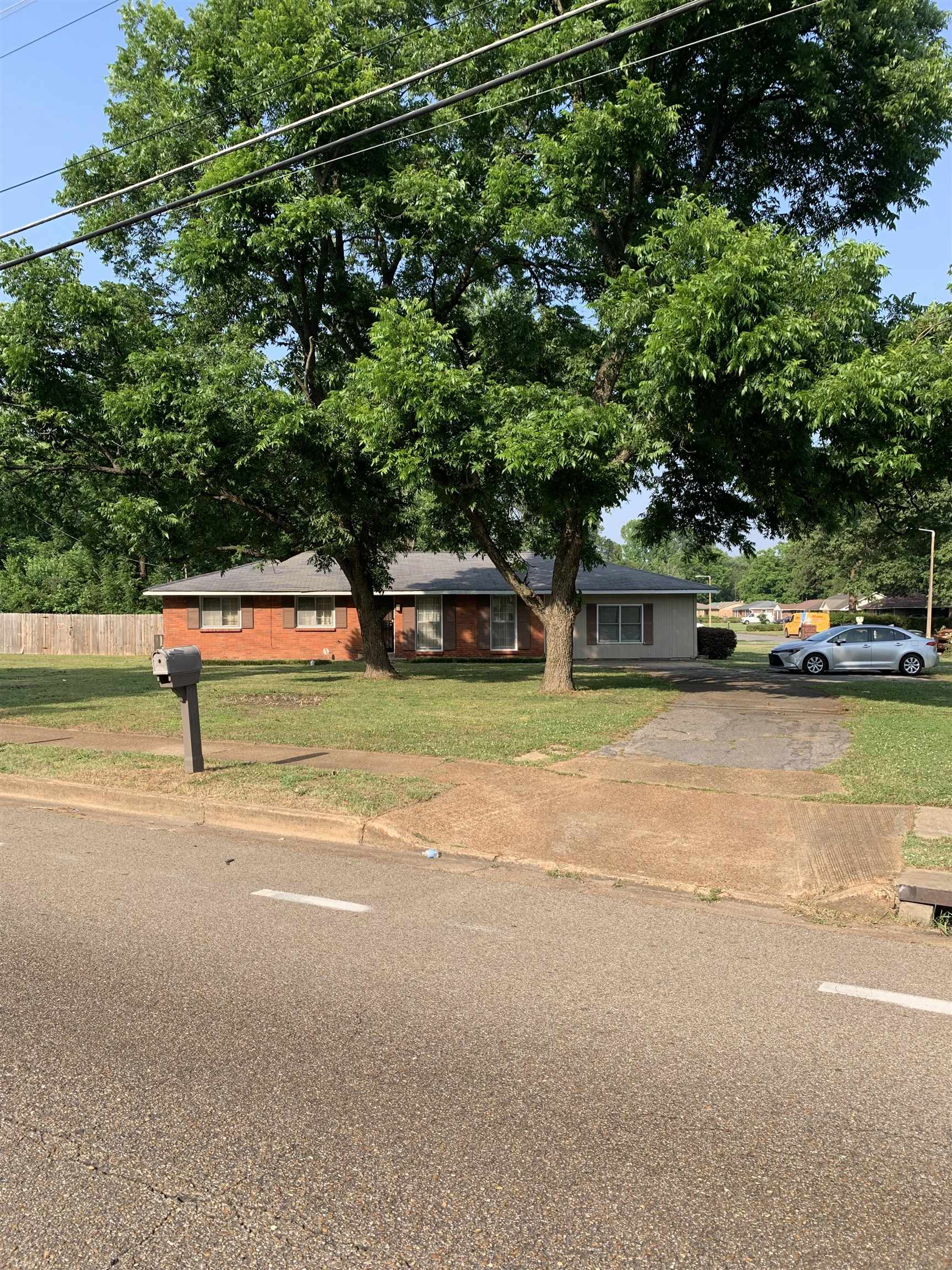 4412 Millbranch Road Memphis, TN 38116 - Photo 4 of 15 a view of a street with a car parked in front of it