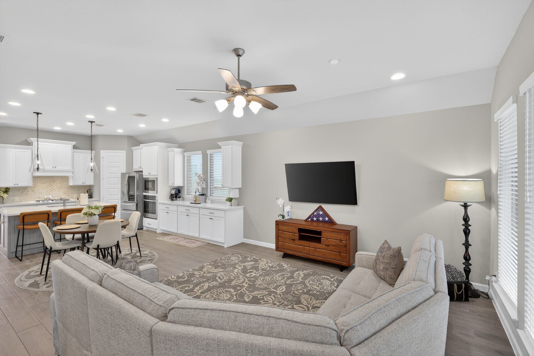 11231 Burgus Farm Road Humble, TX 77346 - Photo 13 of 28 An expansive Great Room featuring a designer kitchen with a massive island, a spacious dining zone with a unique dry bar addition, and a soaring family room. This gently lived-in Perry Home maximizes every square foot, offering a bright, cohesive space that is move-in ready and built for entertaining.