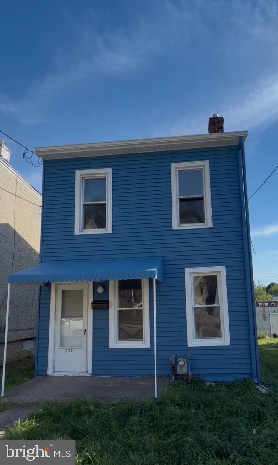 a view of house with yard