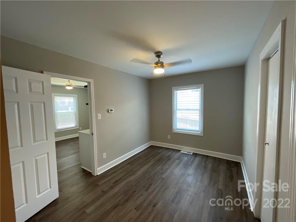 707 Grandin Road Charlotte, NC 28208 - Photo 11 of 19 wooden floor in an empty room with a window