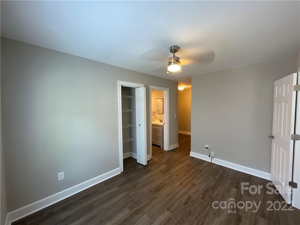 707 Grandin Road Charlotte, NC 28208 - Photo 12 of 19 an empty room with wooden floor and natural light