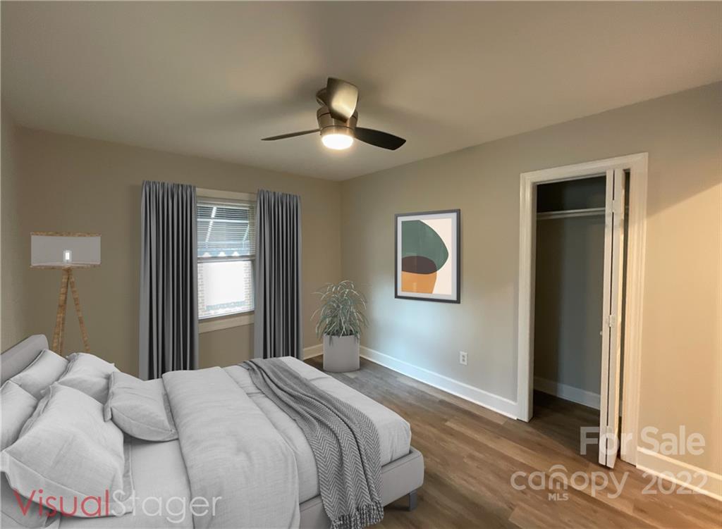 707 Grandin Road Charlotte, NC 28208 - Photo 18 of 19 a bedroom with a large bed and a chandelier