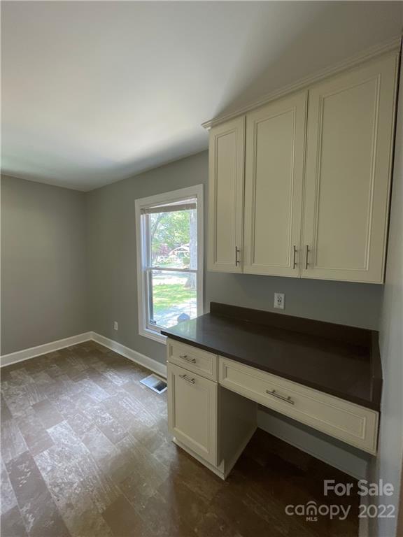 707 Grandin Road Charlotte, NC 28208 - Photo 5 of 19 a kitchen with granite countertop white cabinets and black appliances