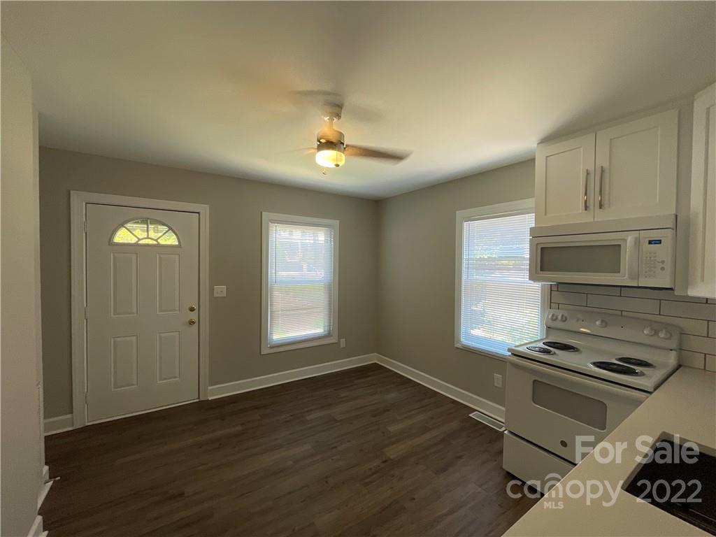 707 Grandin Road Charlotte, NC 28208 - Photo 8 of 19 a kitchen with stainless steel appliances a stove and wooden floor