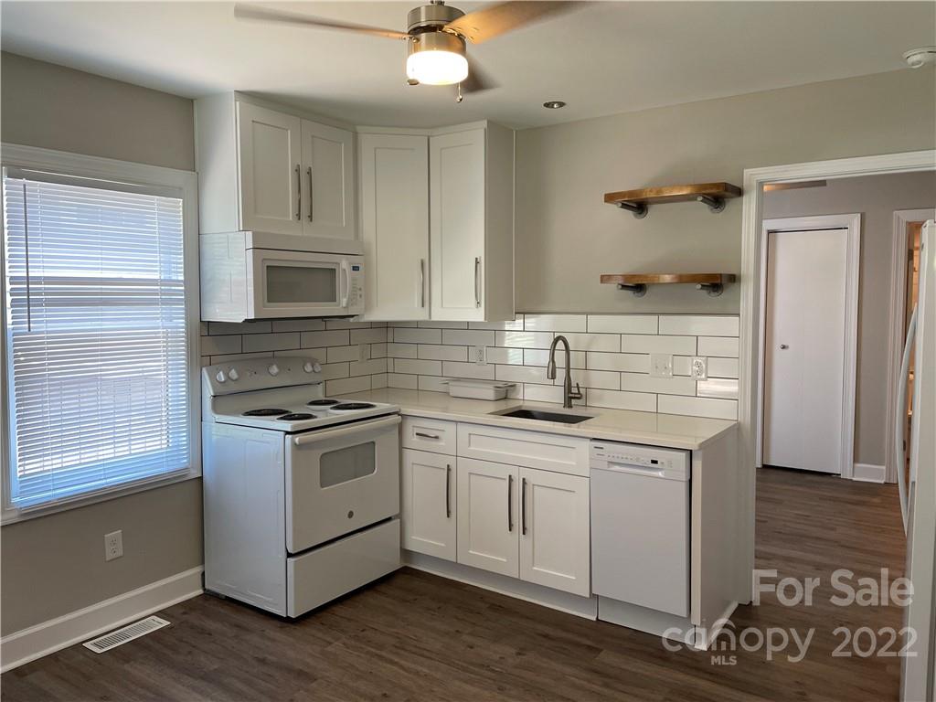 707 Grandin Road Charlotte, NC 28208 - Photo 9 of 19 a kitchen with stainless steel appliances granite countertop a sink stove and cabinets