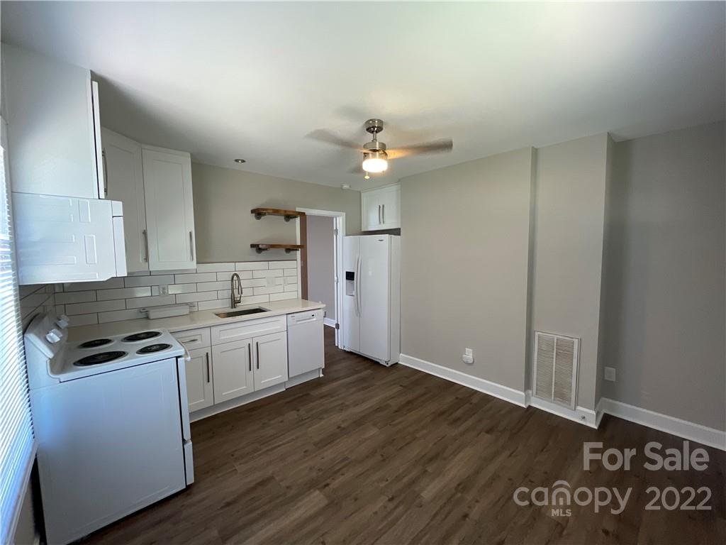 707 Grandin Road Charlotte, NC 28208 - Photo 10 of 19 a kitchen with granite countertop a stove a sink dishwasher and a refrigerator with wooden floor