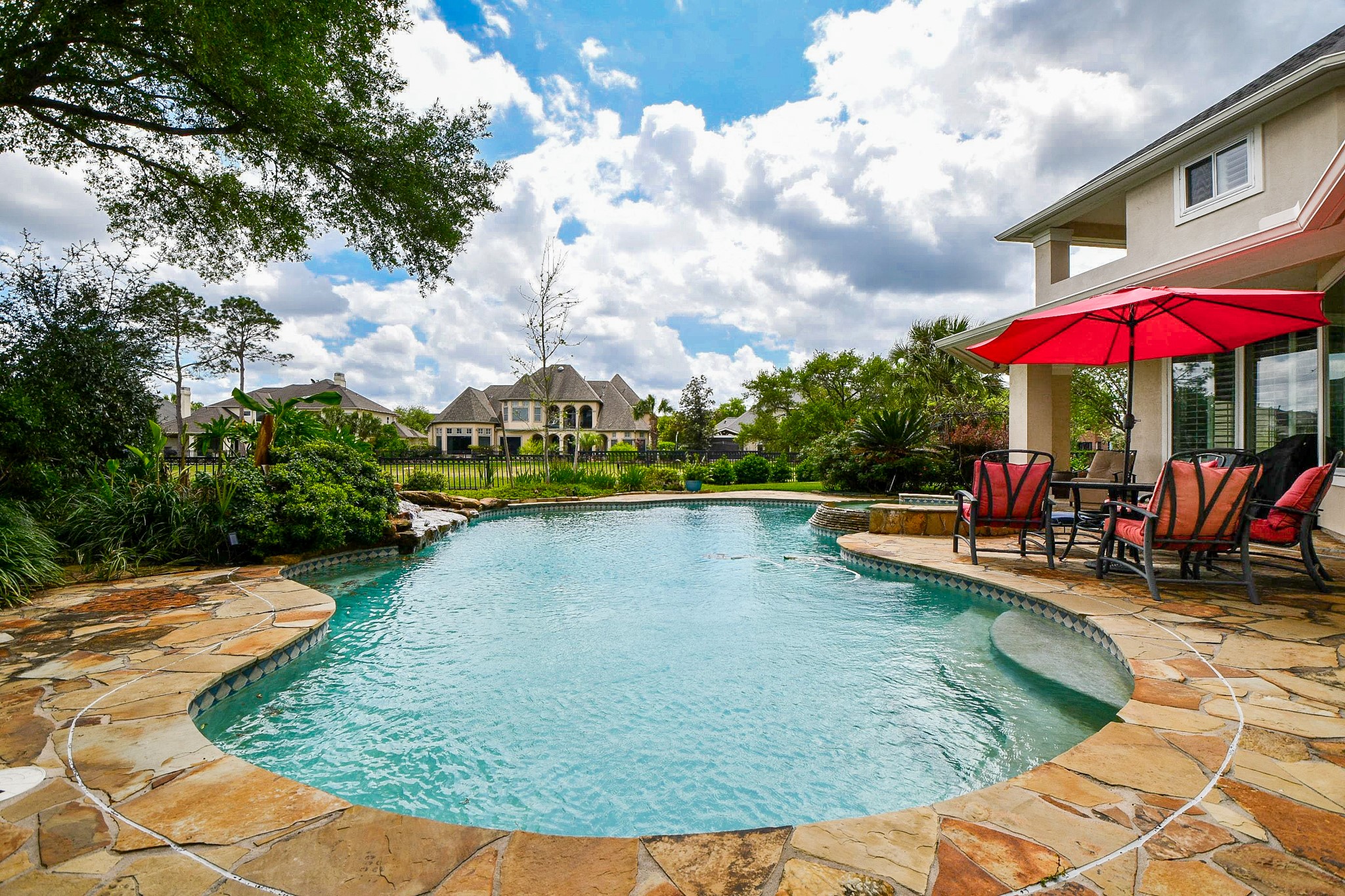 12711 Waterside Way Houston, TX 77041 - Photo 42 of 48 Covered back patio. Beautiful rock waterfall.