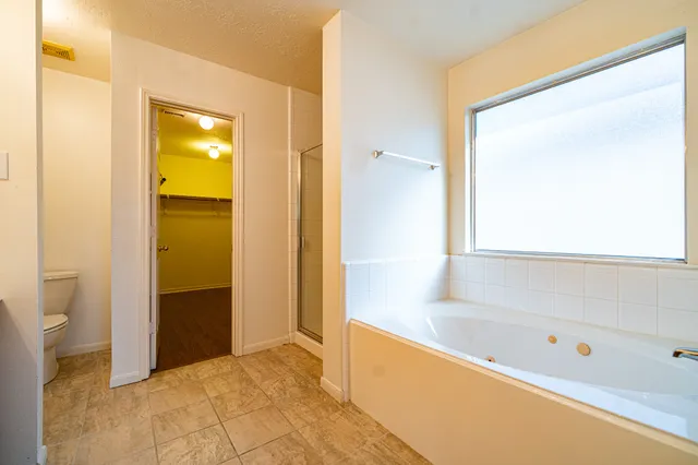 a bathroom with a bathtub and a shower