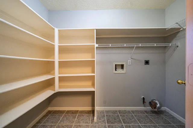 a view of walk in closet with empty racks
