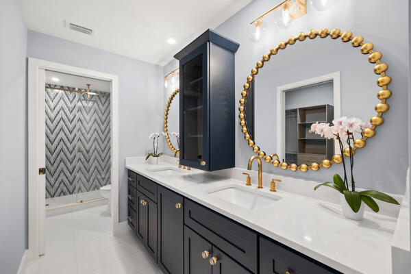 3703 Cape Pointe Circle Jupiter, FL 33477 - Photo 26 of 55 a bathroom with a granite countertop sink and a mirror