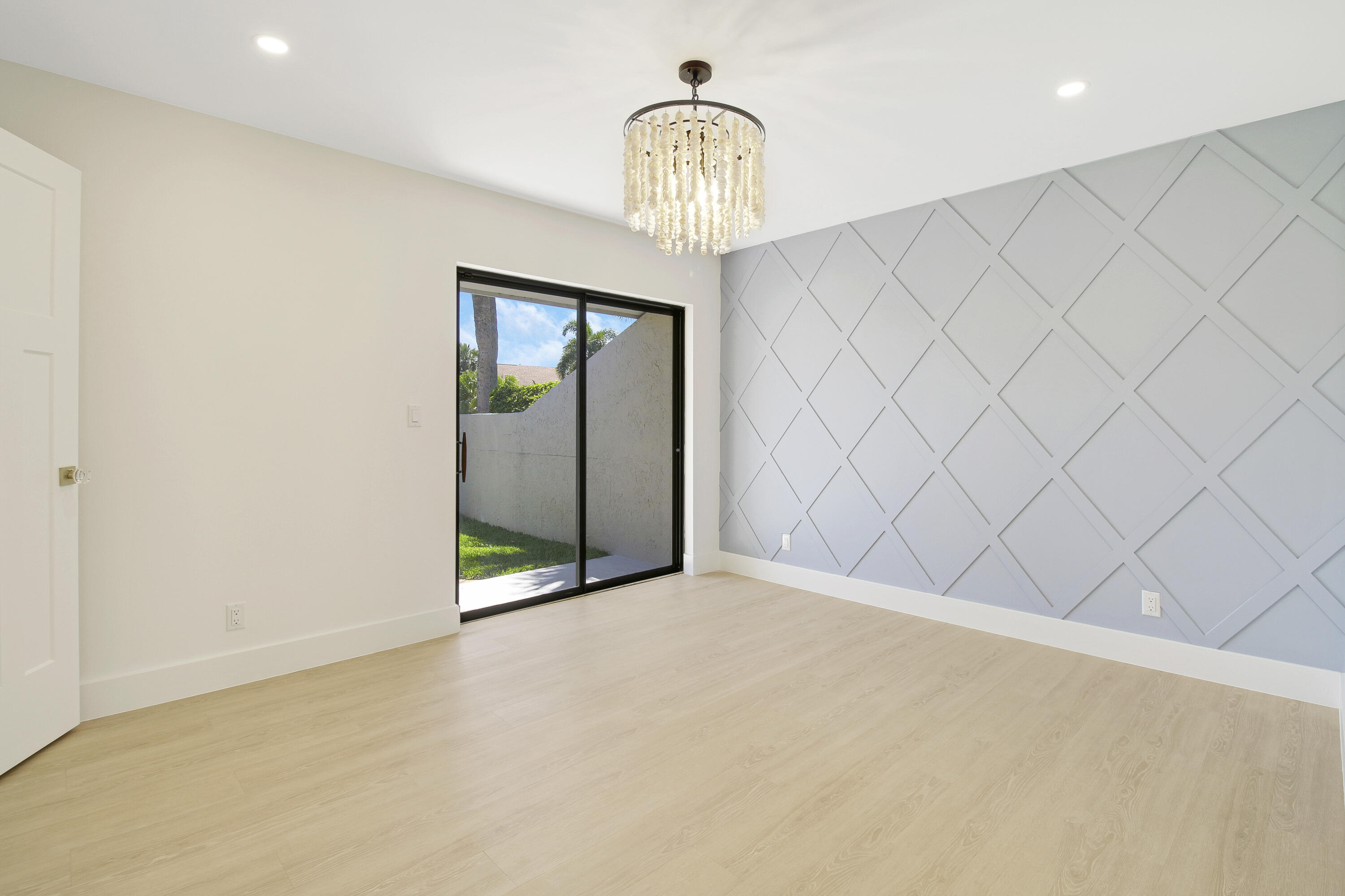 3703 Cape Pointe Circle Jupiter, FL 33477 - Photo 34 of 55 an empty room with a chandelier fan