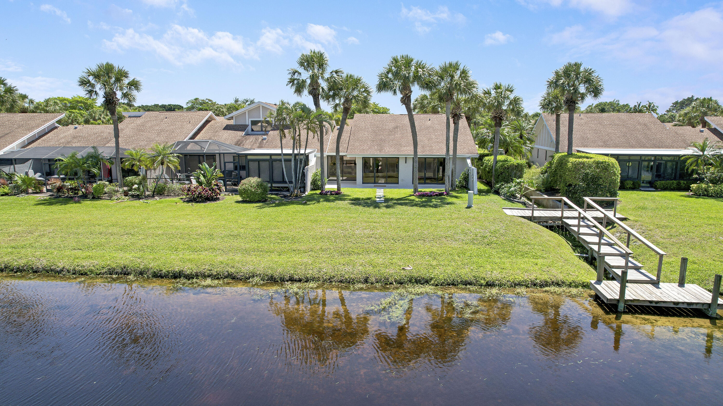 3703 Cape Pointe Circle Jupiter, FL 33477 - Photo 45 of 55 a swimming pool with outdoor seating and yard