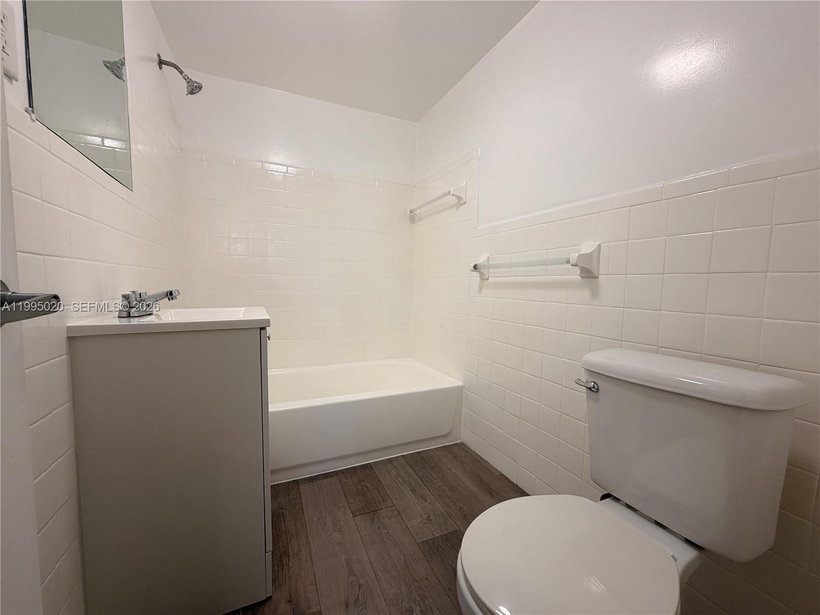 143 Southwest 9th Street, Unit 105 Miami, FL 33130 - Photo 11 of 20 a white toilet sitting next to a bath tub