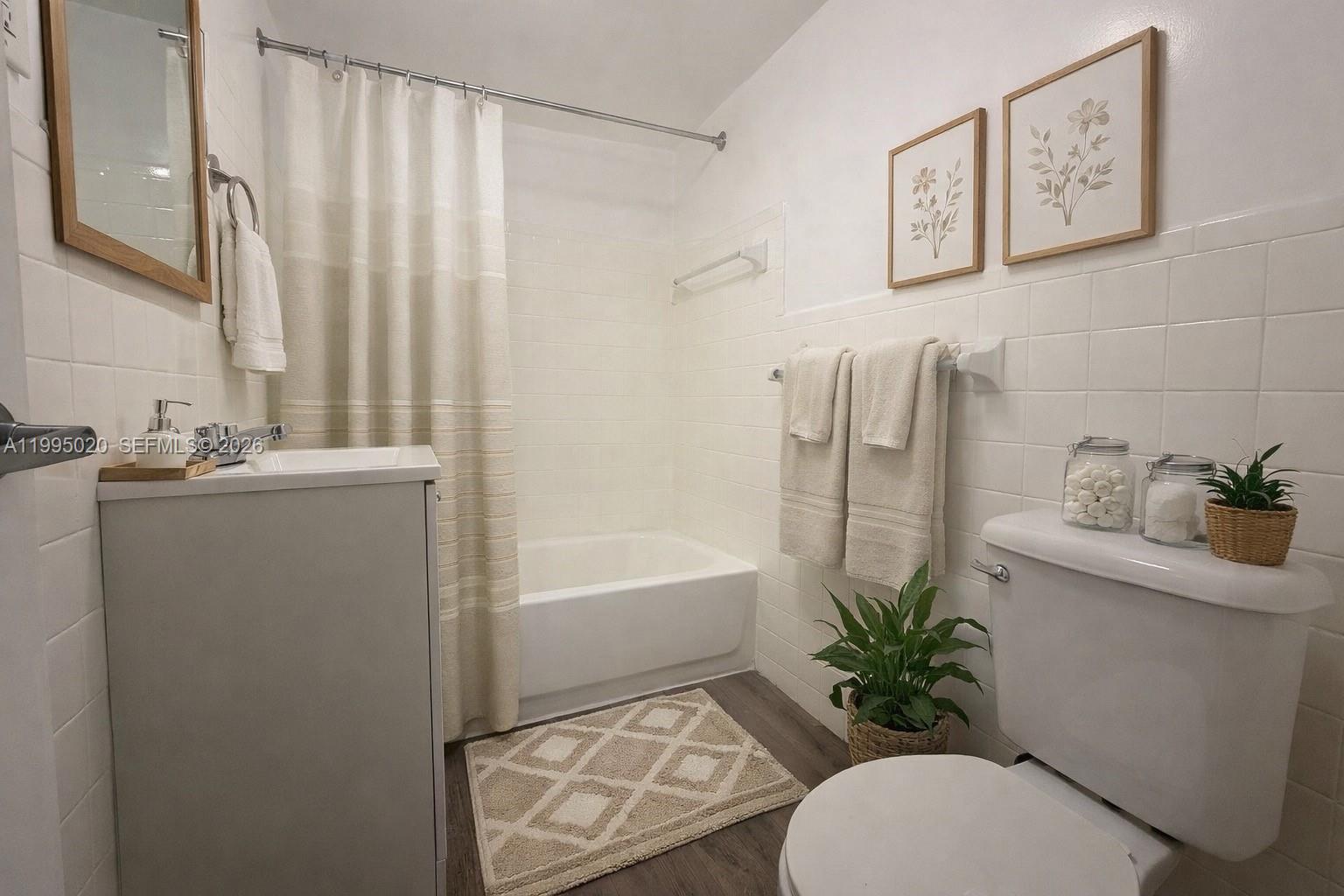 143 Southwest 9th Street, Unit 105 Miami, FL 33130 - Photo 12 of 20 a bathroom with a sink a toilet and tub