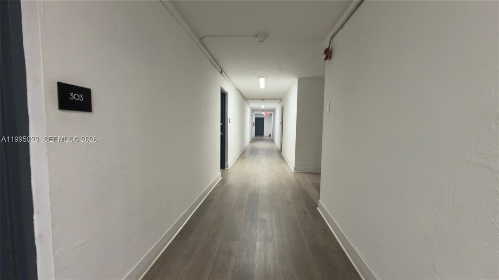 143 Southwest 9th Street, Unit 105 Miami, FL 33130 - Photo 14 of 20 a view of a hallway with wooden floor
