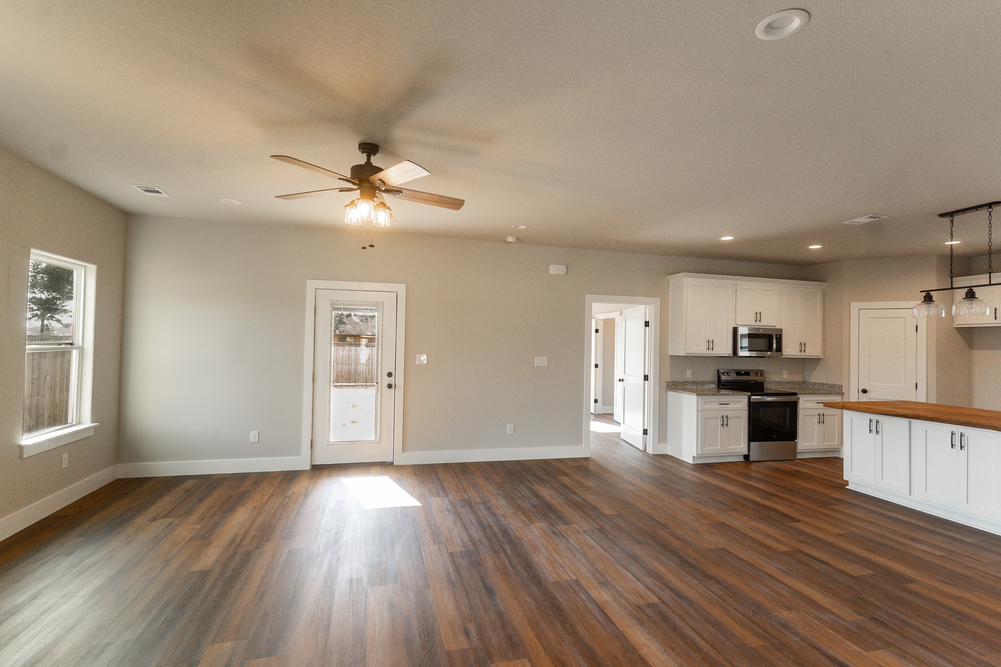 305 String Prairie Way Smithville, TX 78957 - Photo 8 of 26 a view of kitchen with cabinets stainless steel appliances a sink and a stove