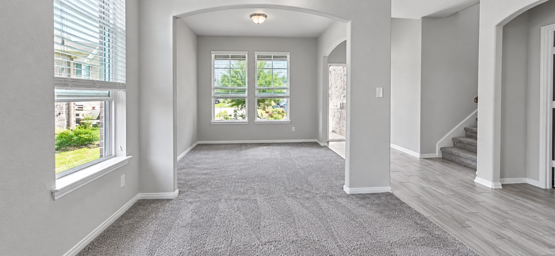 11355 Cascading Stream Way Houston, TX 77044 - Photo 4 of 17 Bright and inviting living area with plush carpeting, abundant natural light from large windows, and a seamless flow into adjacent spaces, perfect for relaxation and entertaining.