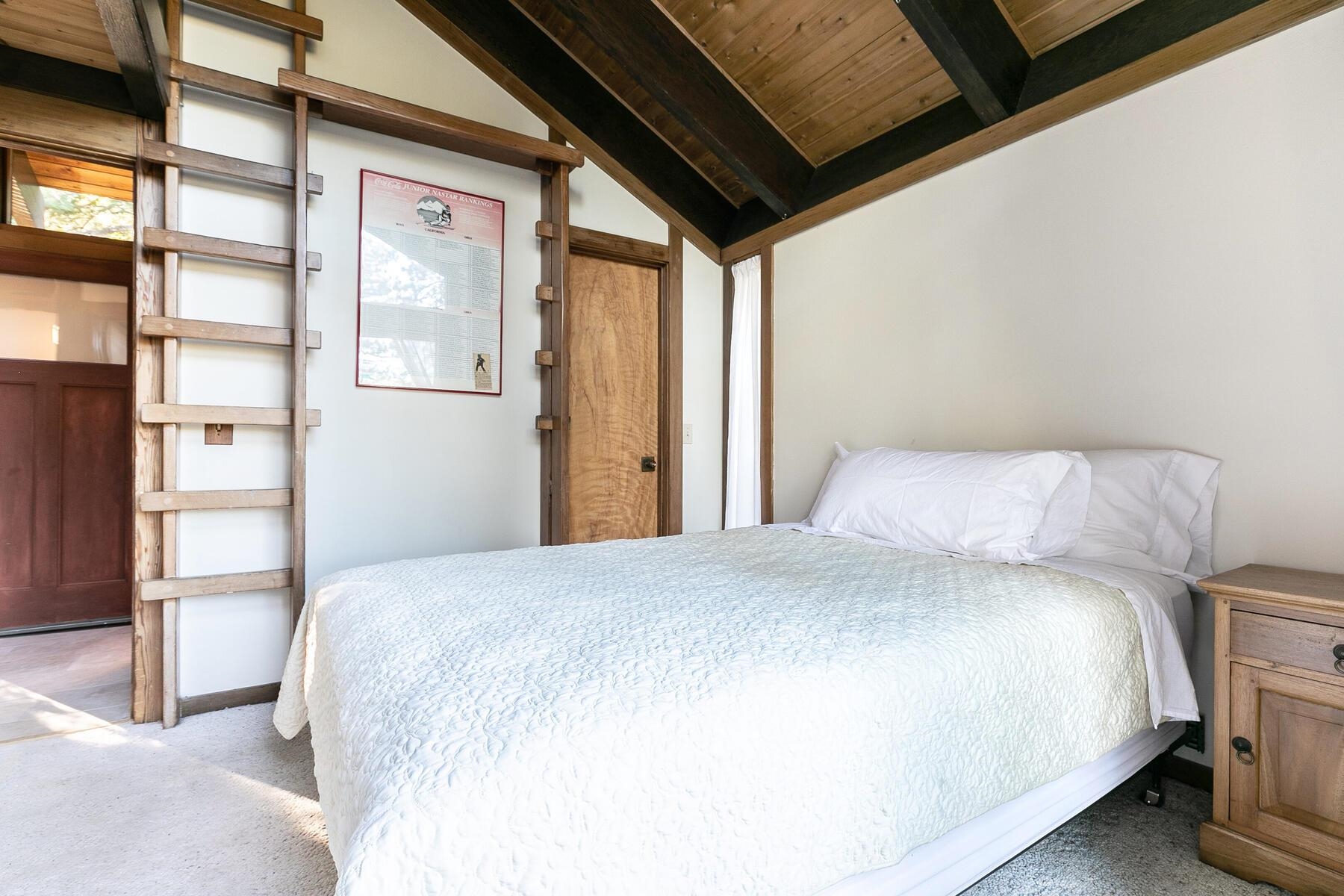 1469 Sandy Way Olympic Valley, CA 96146 - Photo 13 of 21 a bedroom with a bed and a large window