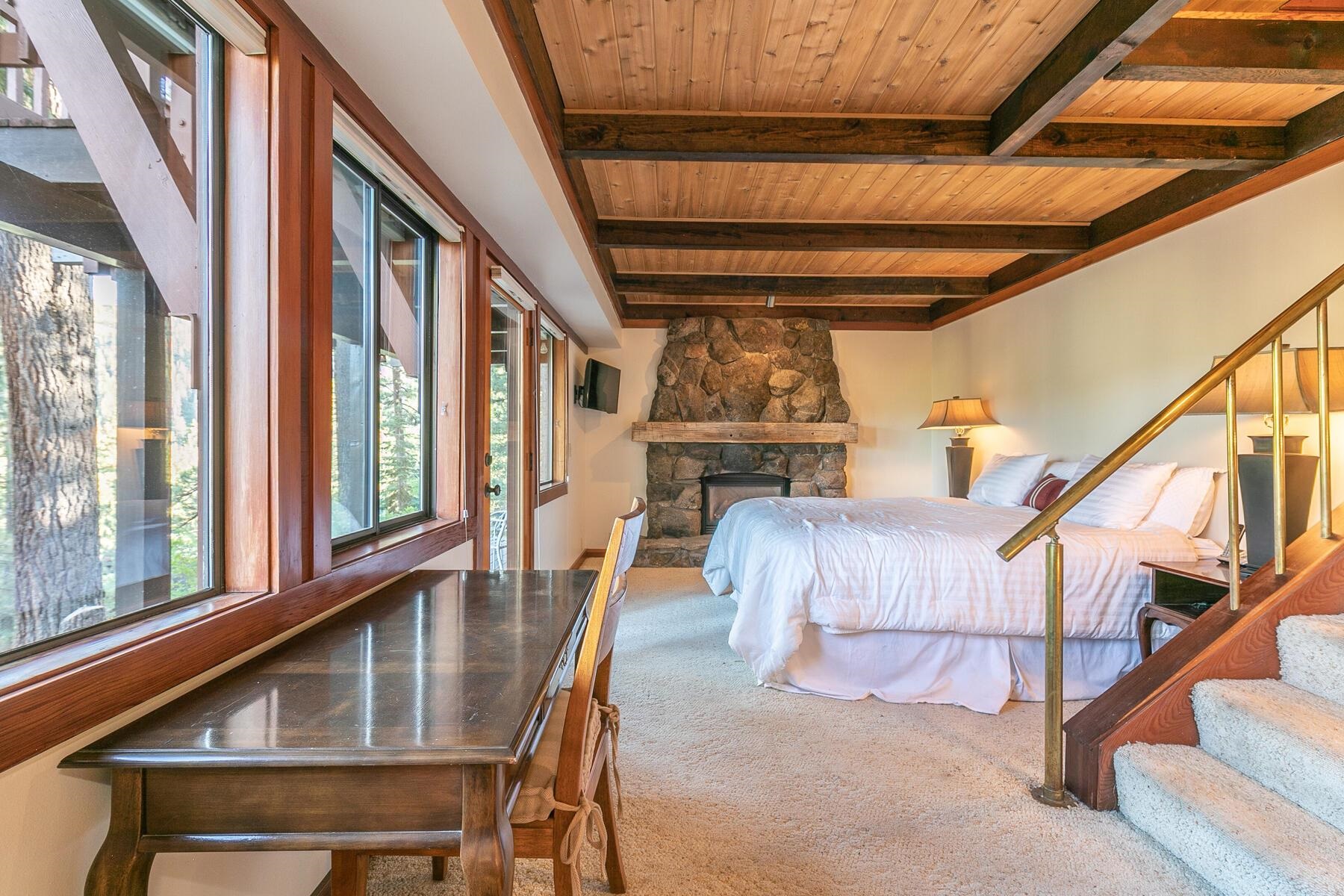 1469 Sandy Way Olympic Valley, CA 96146 - Photo 16 of 21 a living room with furniture stairs and a large window