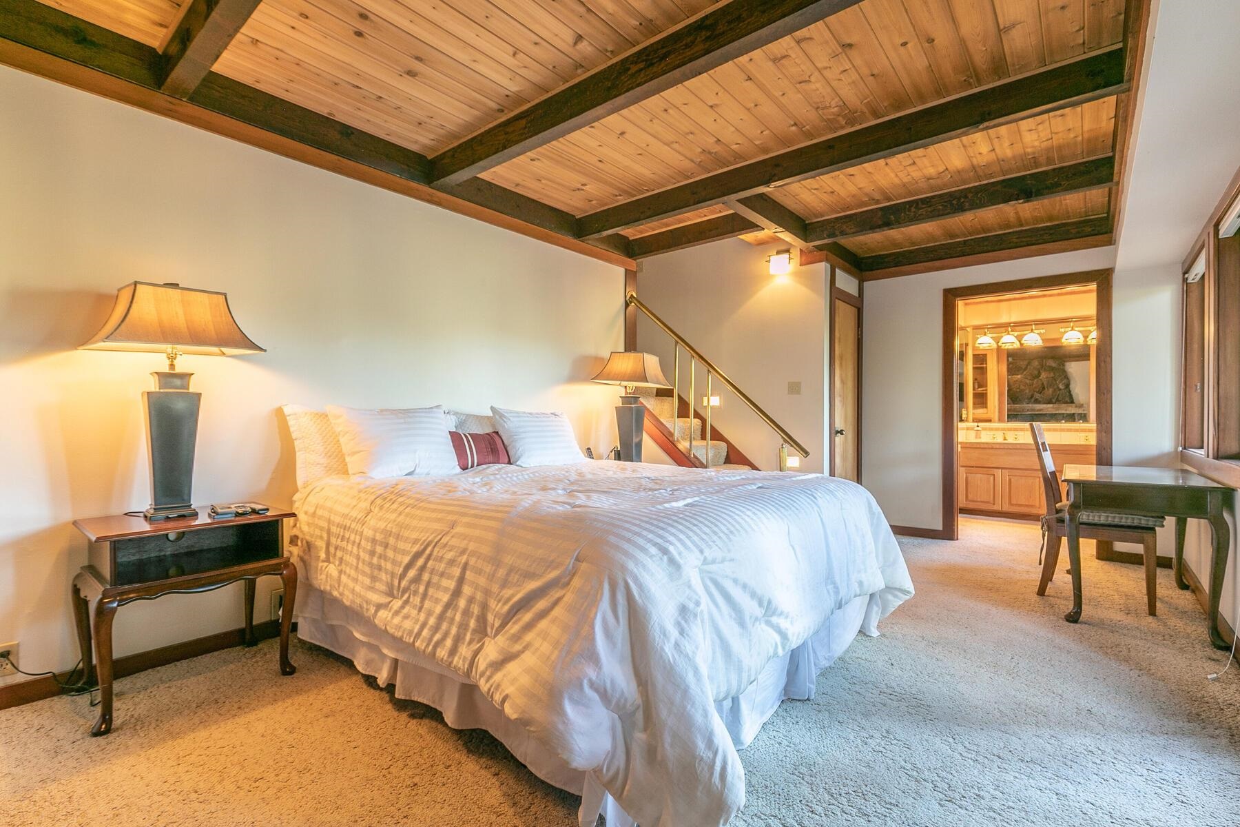 1469 Sandy Way Olympic Valley, CA 96146 - Photo 17 of 21 a bedroom with a bed and a lamp with the dresser