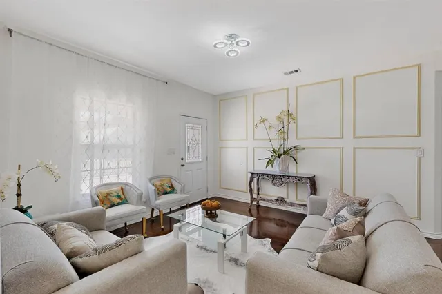 a living room with furniture and a chandelier
