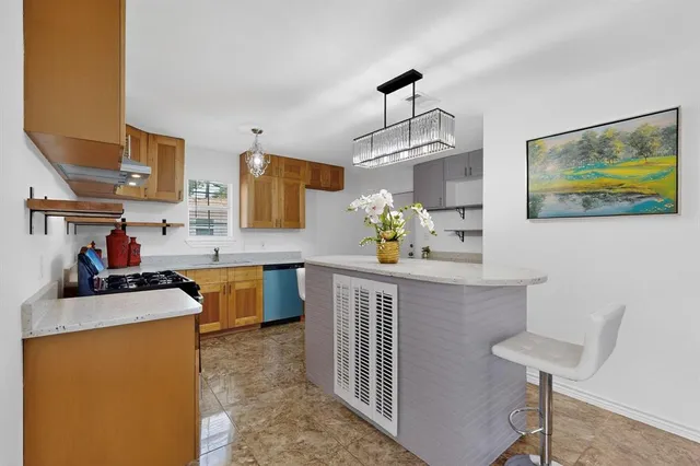 a kitchen with stainless steel appliances granite countertop a sink stove and a refrigerator