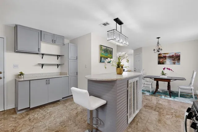 a kitchen with sink cabinets and chairs
