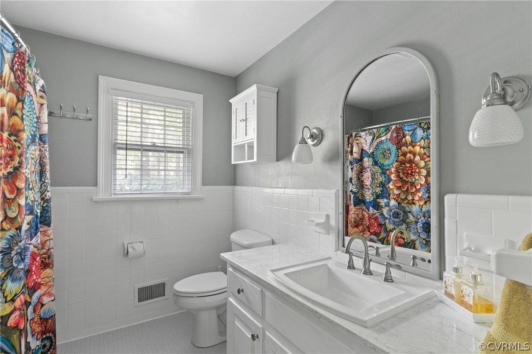 4430 Croatan Road Richmond, VA 23235 - Photo 30 of 44 a bathroom with a sink toilet and mirror