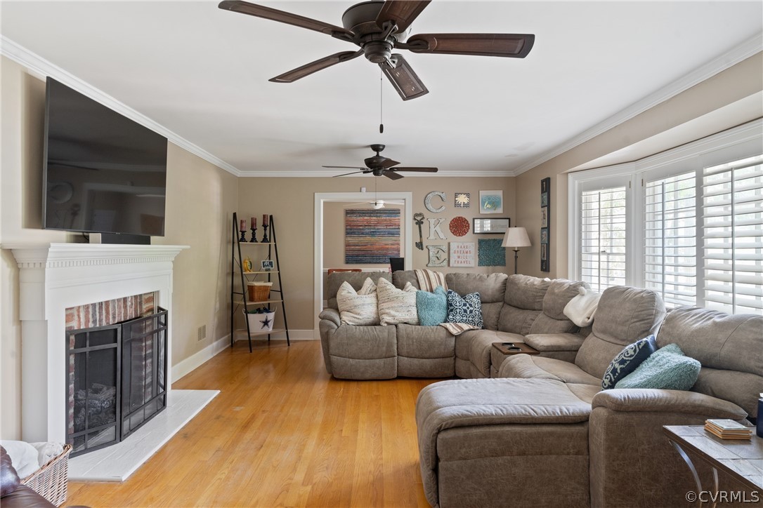 4430 Croatan Road Richmond, VA 23235 - Photo 4 of 44 a living room with furniture a flat screen tv and a fireplace