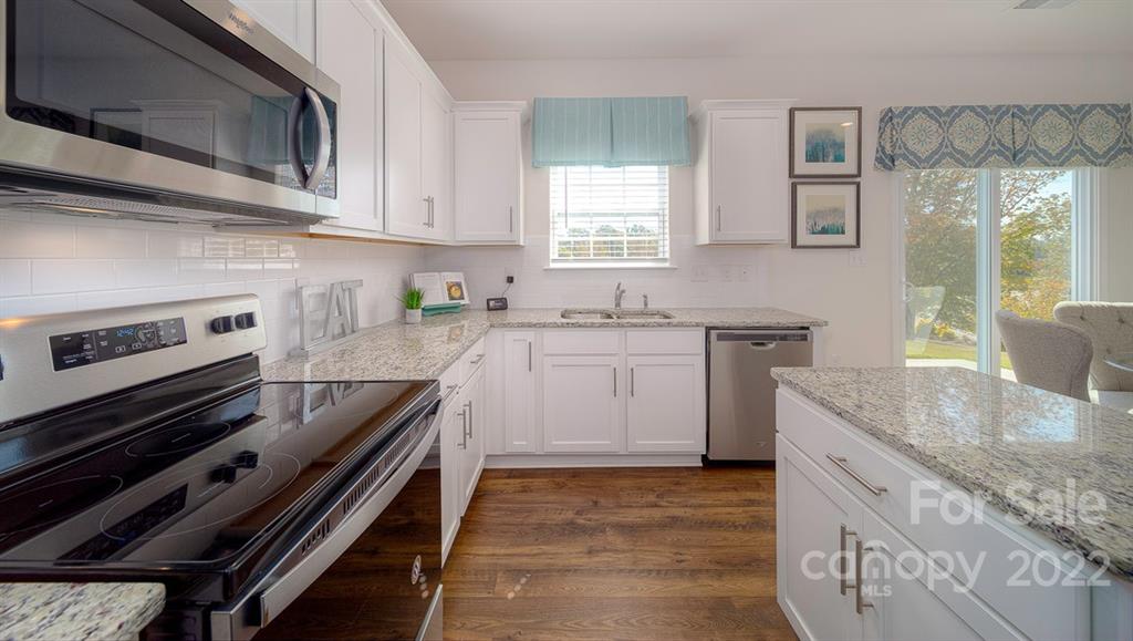 309 Gaines Road Clover, SC 29710 - Photo 25 of 48 a kitchen with a stove sink and cabinets