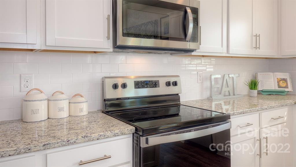 309 Gaines Road Clover, SC 29710 - Photo 26 of 48 a kitchen with granite countertop a stove and a sink