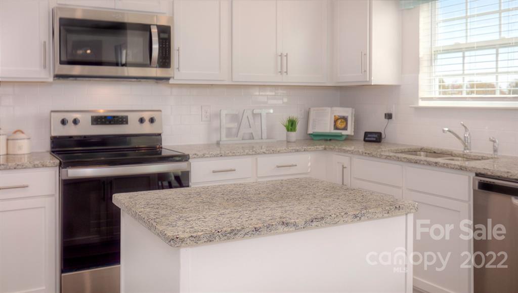 309 Gaines Road Clover, SC 29710 - Photo 27 of 48 a kitchen with granite countertop a sink and a stove top oven