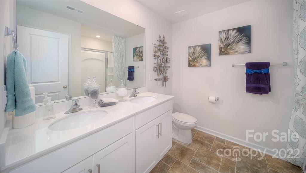 309 Gaines Road Clover, SC 29710 - Photo 29 of 48 a bathroom with a double vanity sink toilet and a mirror