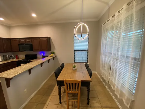 a very nice looking dining room with a table and chairs