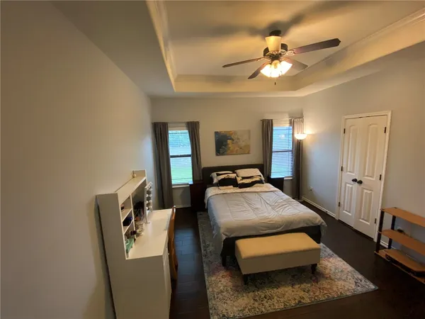 a bedroom with bed and a chandelier