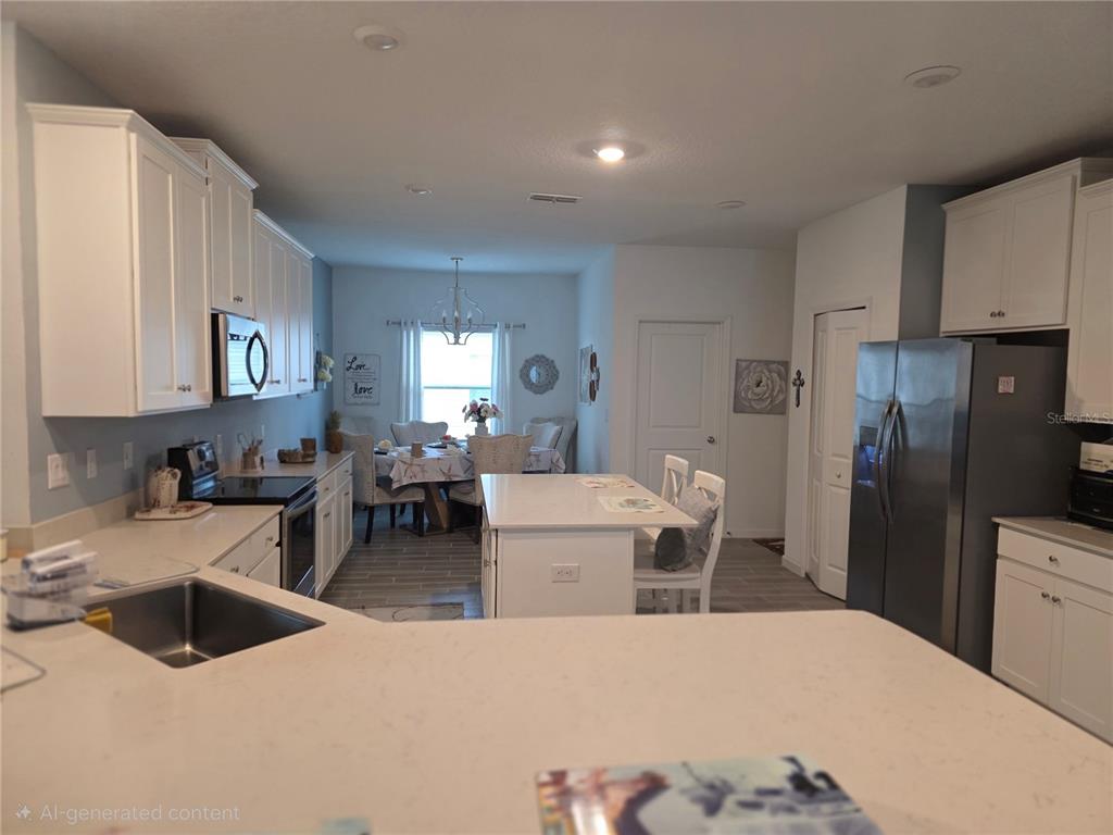 7875 Southwest 74th Street Ocala, FL 34474 - Photo 13 of 28 a large white kitchen with stainless steel appliances