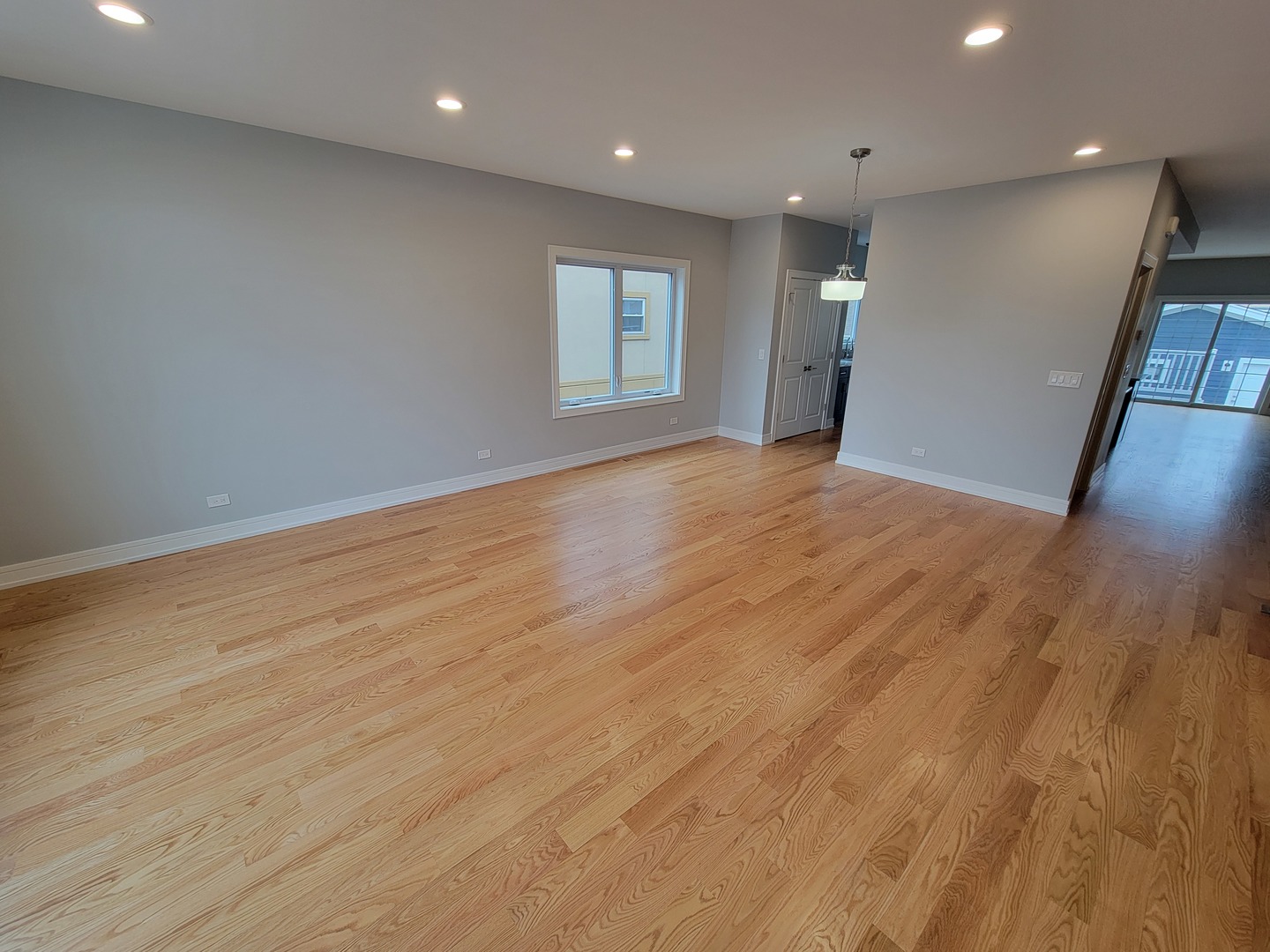 2918 North Rutherford Avenue Chicago, IL 60634 - Photo 2 of 18 a view of empty room with wooden floor and window