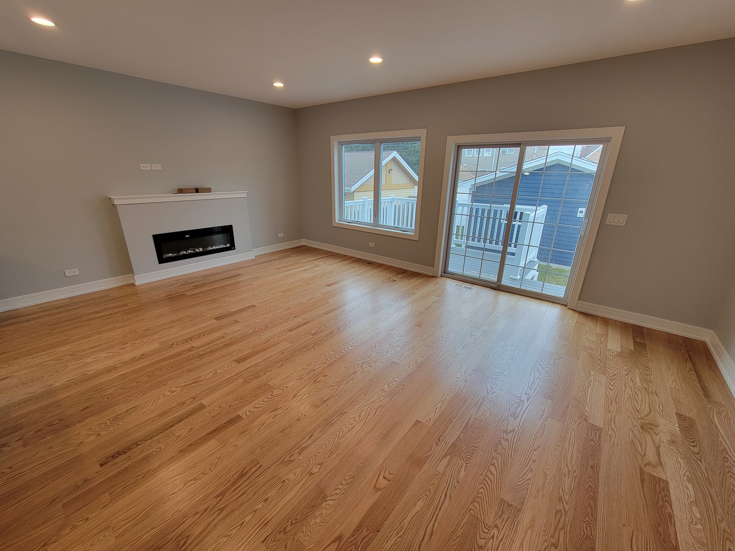 2918 North Rutherford Avenue Chicago, IL 60634 - Photo 5 of 18 an empty room with wooden floor and fireplace