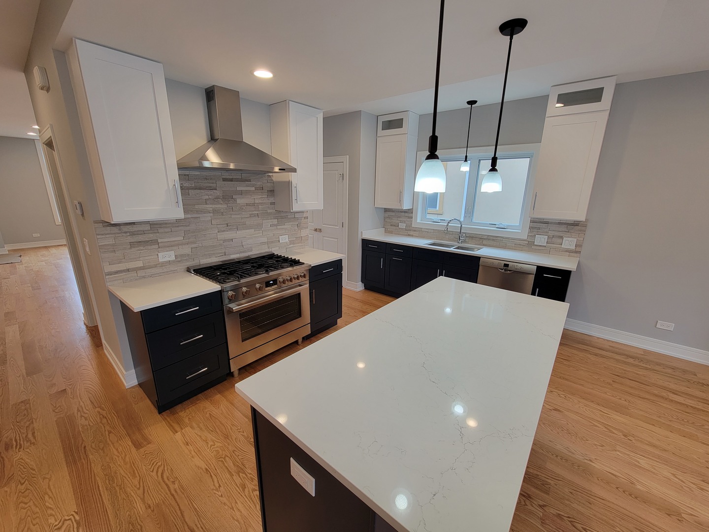 2918 North Rutherford Avenue Chicago, IL 60634 - Photo 7 of 18 a kitchen with stainless steel appliances granite countertop a sink a stove and a wooden floors