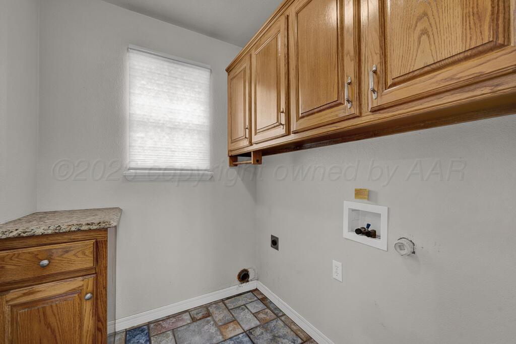 19933 Indian Spring Trail Bushland, TX 79124 - Photo 12 of 32 a bathroom with a granite countertop sink and cabinets