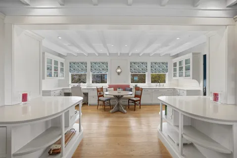 a dining room with furniture and a floor to ceiling window