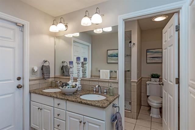 317 Beach Drive Aptos, CA 95003 - Photo 21 of 41 a bathroom with a granite countertop sink a toilet and a mirror