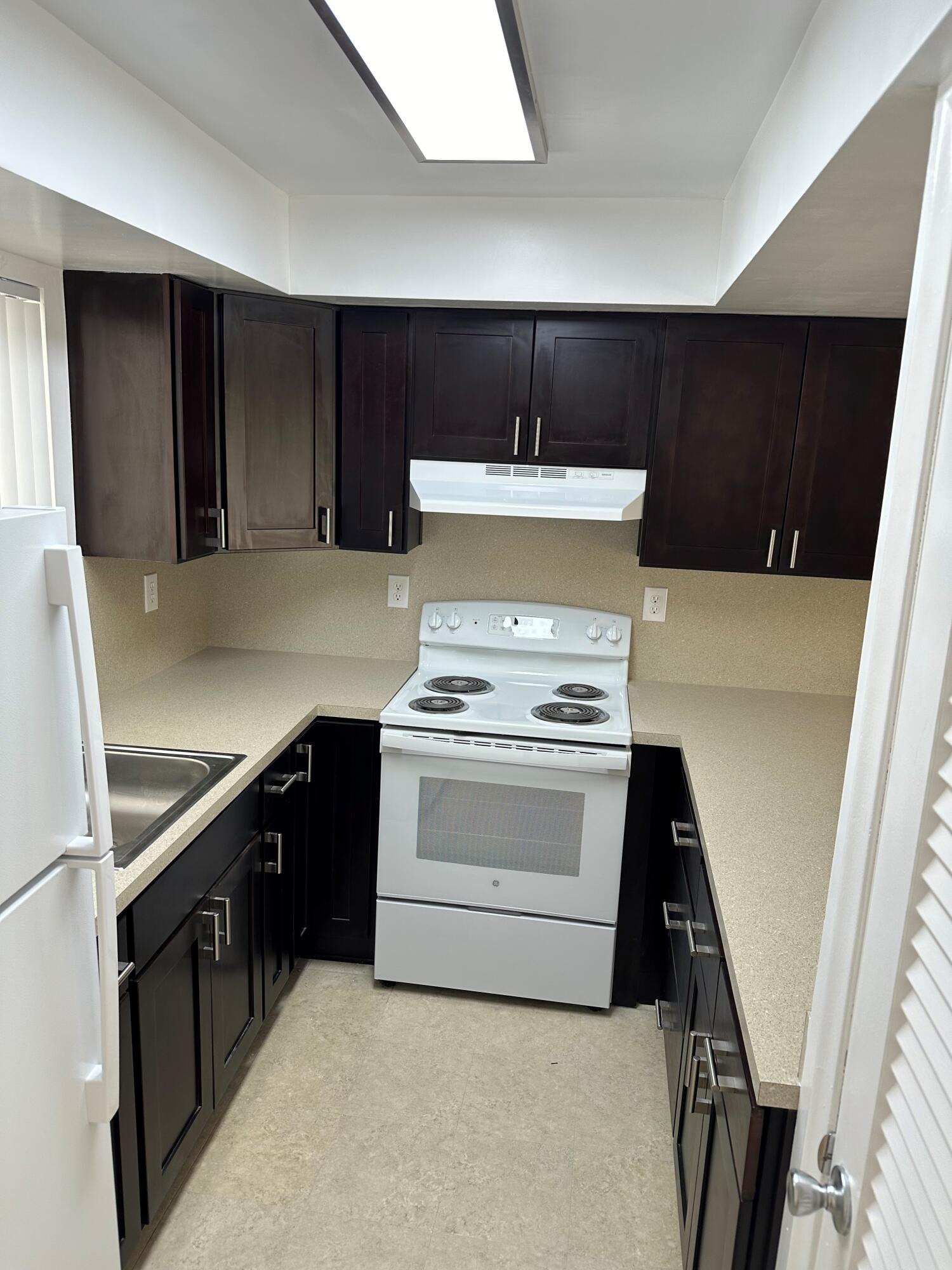 a kitchen with a stove and a refrigerator