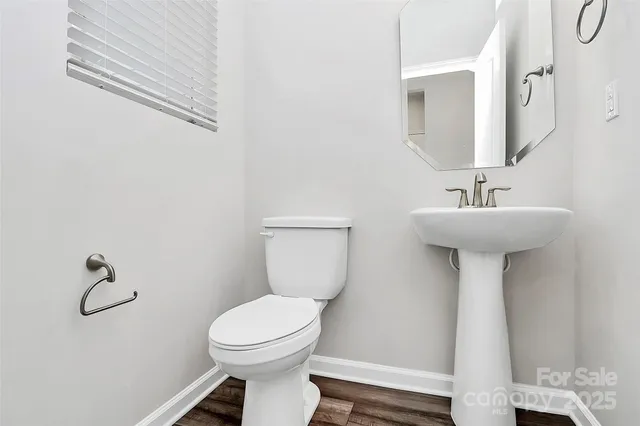 a bathroom with a sink mirror and toilet